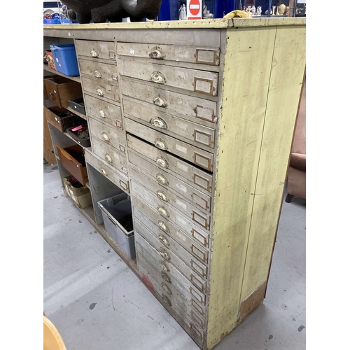 57 - Furniture: 20th cent. Pitch pine workshop storage unit with twenty-three drawers and six storage com... 