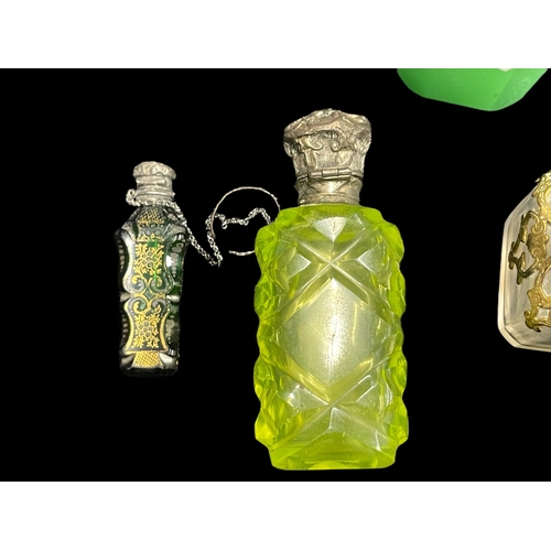 570 - Objects of Vertu: Victorian and later silver and white metal mounted scent bottles together with a p... 