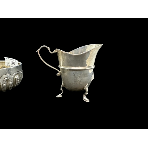 688 - Silver: Cream jug standing upon three hoofed feet, London 1886, plus a bowl decorated with wheat and... 