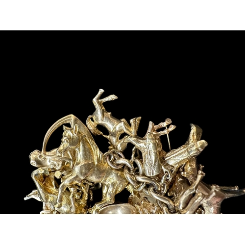 799 - Hallmarked Gold: An impressive 9ct gold charm bracelet, equestrian-themed, in excess of thirty hallm... 