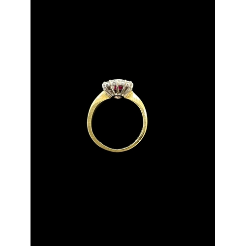 816 - Jewellery: 18ct. gold cluster ring, central ruby within a band of 14 small diamonds. 4.3g.... 