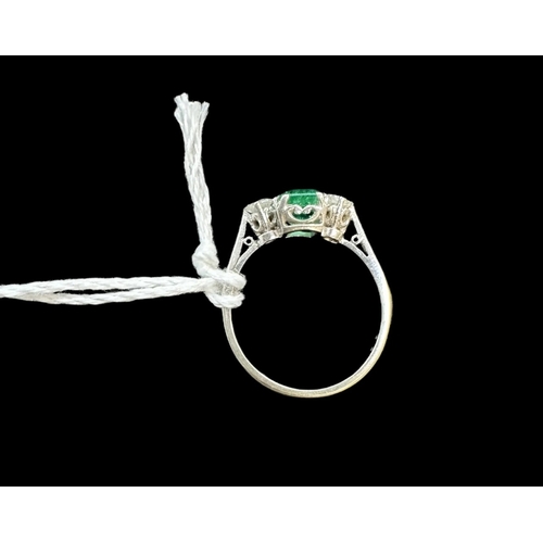 825 - Hallmarked Jewellery: 18ct white gold trilogy ring, central emerald approx. 1ct, flanked by two diam... 