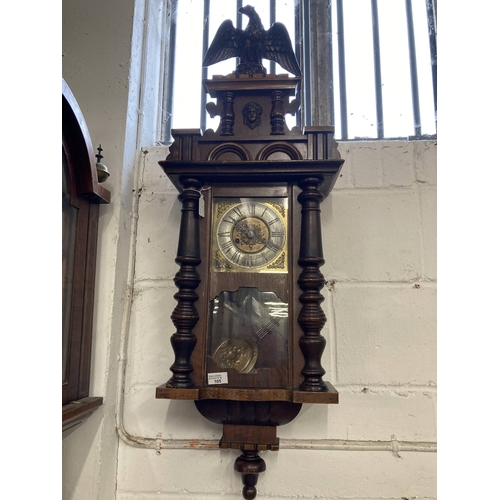 105 - Clocks: 19th cent. Walnut veneer Black Forest wall clock with eagle finial and turned columns. Heigh... 