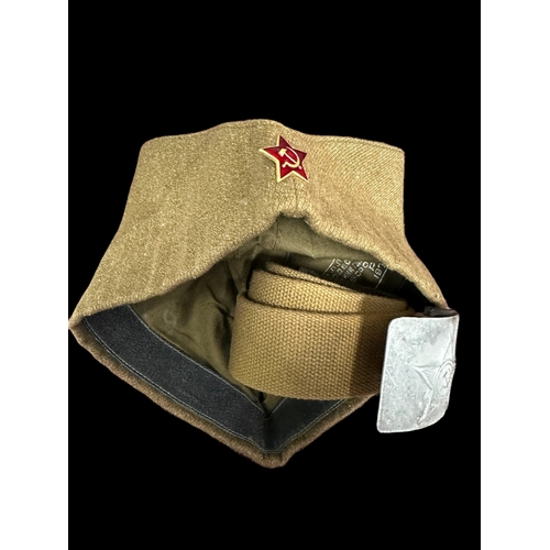 273 - Militaria: Soviet Russian items, Ushanka fur hat, side cap, belt and buckle.