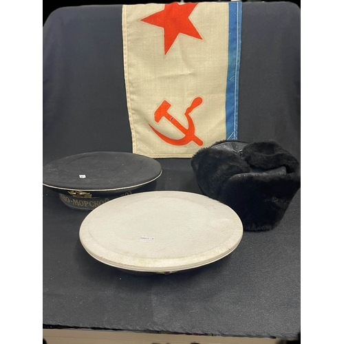 298 - Militaria: 20th cent. Russian fur hat, two different sailors' caps and submarine flag. (4)... 