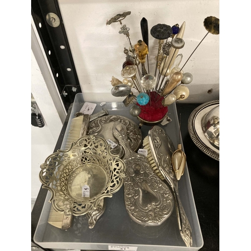 31 - Silver Plate: Four-piece silver-plated dressing table set, a pair of knife rests, a bonbon dish, a p... 