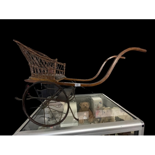 385 - Toys: Early 20th cent. Dog cart wicker and oak with iron chassis.