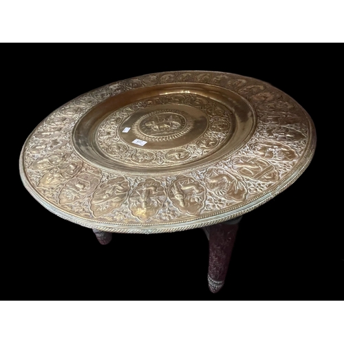 517 - Furniture: 19th/20th cent. Indo-Persian brass circular supper ornately carved folding supports. Diam... 