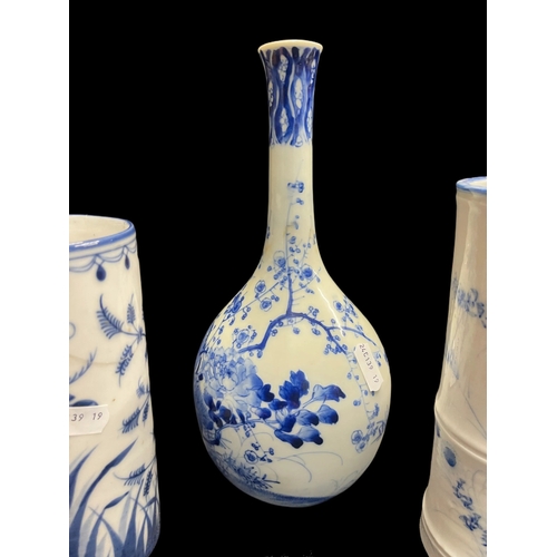 530 - Ceramics: Blue and white bottle vase painted with a bird amongst blossom, 24½cm, plus two further bl... 