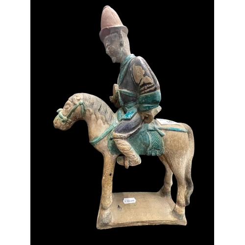 540 - Chinese: Chinese: Ming Period stoneware burial figure in the form of men on horseback in an aubergin... 