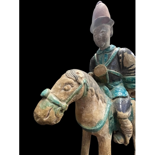 540 - Chinese: Chinese: Ming Period stoneware burial figure in the form of men on horseback in an aubergin... 