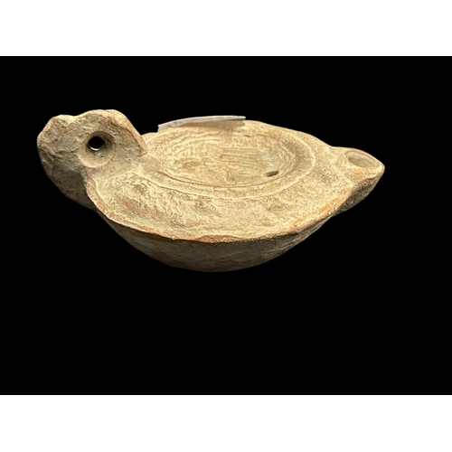 551 - Antiquities: Antiquities: Roman terracotta oil lamp with impressed figural decoration, 9cm. together... 