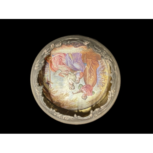 555 - Continental Silver: White metal snuff box the lid enamelled with an image of three young women recli... 