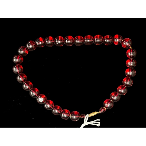 556 - Jewellery: Ruby amber necklace 29 beads plus 2, approximate length 15ins.