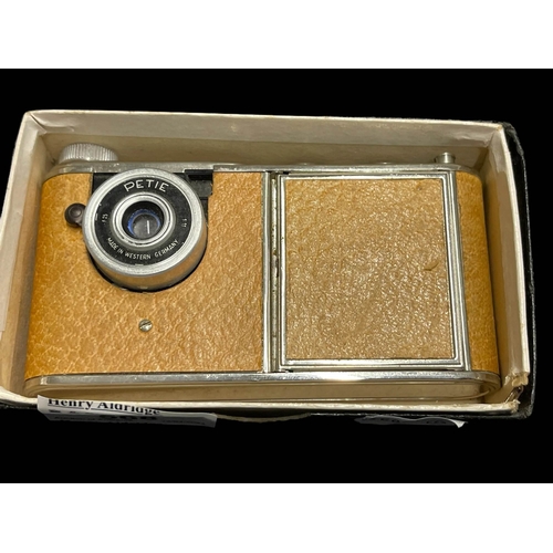 568 - Cameras: Petie Compact miniature camera tan body, single speed shutter, 11/25mm lens 'Leica'. In goo... 