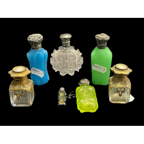 570 - Objects of Vertu: Victorian and later silver and white metal mounted scent bottles together with a p... 