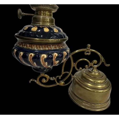 625 - Lamps: Weighted oil lamp with gadrooned pottery blue ground bowl, marked for Kaester & Tobleman.... 