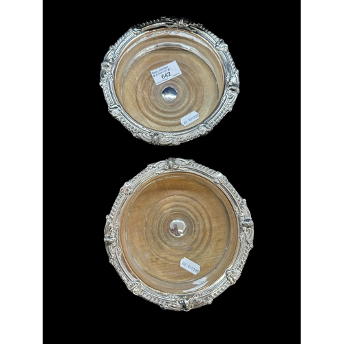 642 - Sheffield Plate: Bottle coasters with gadroon and scroll rim and oak base, internal dia. 13cm, a pai... 