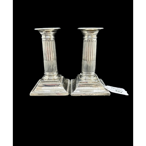 654 - Hallmarked Silver: Pair of short Corinthian column candlesticks. Total weight 19.4ozt.