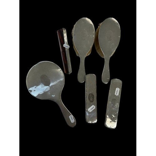 663 - Silver: Part silver dressing table set to include four brushes, one comb and a hand mirror, Birmingh... 