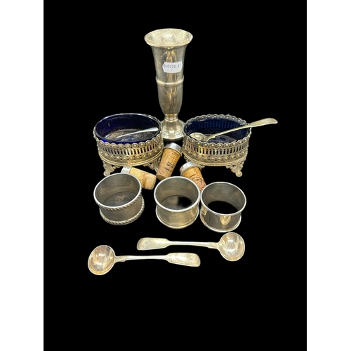 671 - Hallmarked Silver: Three silver napkin rings, three condiment spoons, three bottle stoppers, spill v... 