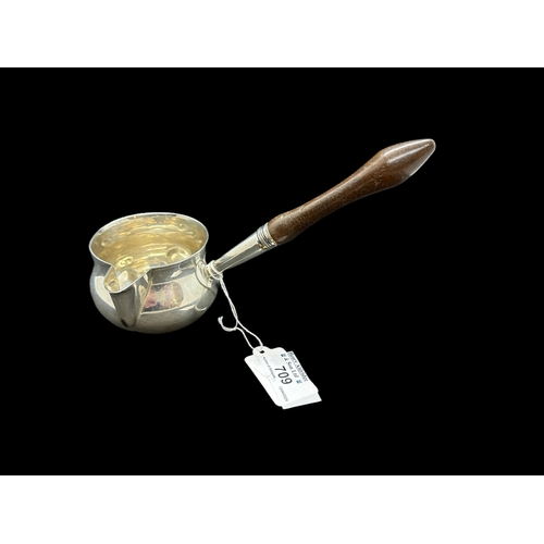 709 - Silver: Toddy ladle with turned wooden handle to a plain bowl, London 1802, Gross weight 118g.... 