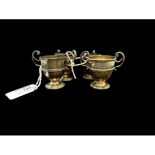 723 - Hallmarked Silver: Hallmarked Silver: Set of four egg cups with c scroll handles, hallmarked London.... 