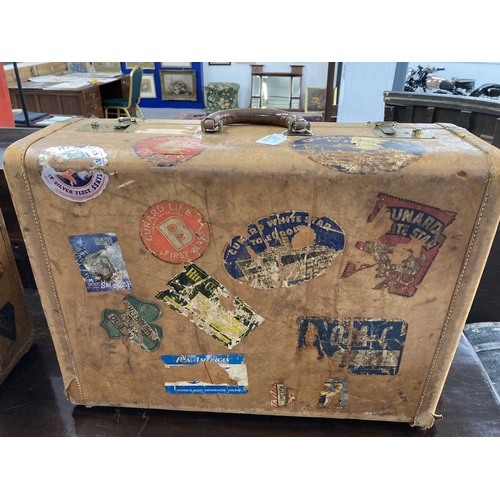 73 - Mid 20th cent. Travel: Tan leather suitcases with various travel labels of the period including Cuna... 