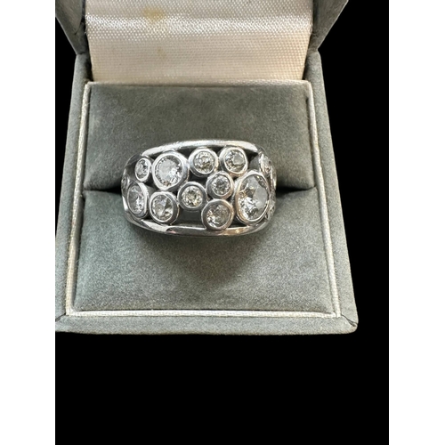 742 - Hallmarked Jewellery: 18ct white gold turban style ring rub-over set with sixteen brilliant cut diam... 