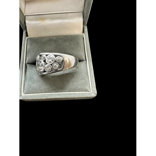 742 - Hallmarked Jewellery: 18ct white gold turban style ring rub-over set with sixteen brilliant cut diam... 