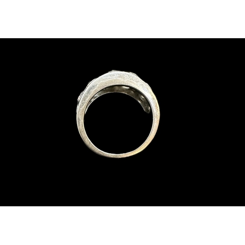 742 - Hallmarked Jewellery: 18ct white gold turban style ring rub-over set with sixteen brilliant cut diam... 