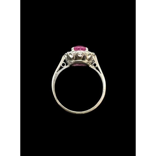 748 - Jewellery: White metal cluster ring centre set with a cushion cut ruby, estimated weight 1.50ct, sur... 