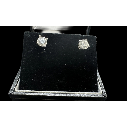 775 - Hallmarked Jewellery: Pair of 18ct gold earrings each set with a brilliant cut diamond, estimated we... 