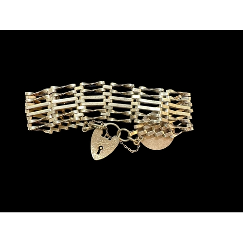 790 - Hallmarked Jewellery: 9ct gold gate link bracelet with heart shaped padlock and attached fob. 28.2g.... 