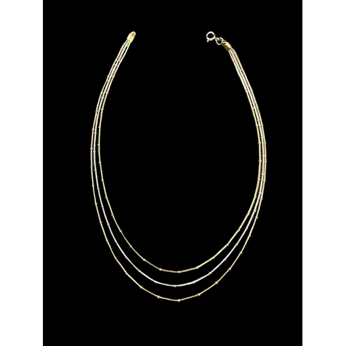 797 - Hallmarked Gold: Yellow, white and rose gold three strand necklace, each strand with regular bead de... 