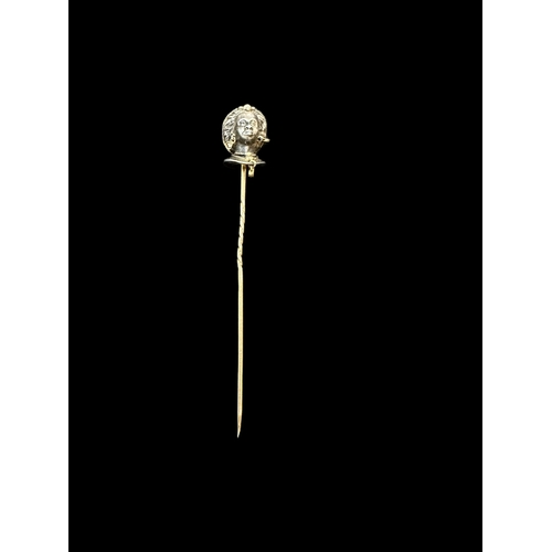 806 - Jewellery: Yellow and white metal stick pin modelled as a blackamoor wearing diamond earrings and ne... 