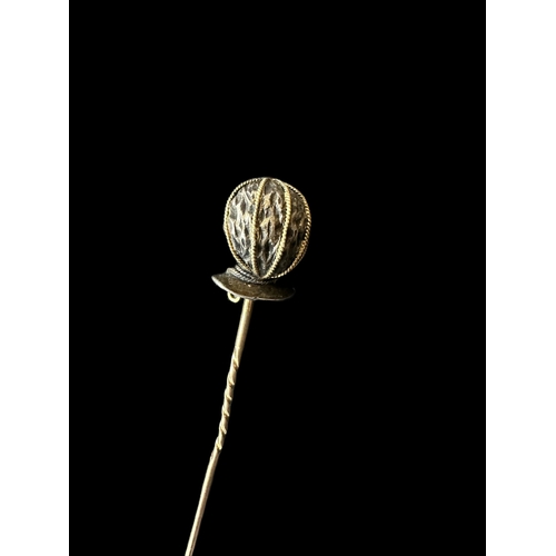 806 - Jewellery: Yellow and white metal stick pin modelled as a blackamoor wearing diamond earrings and ne... 