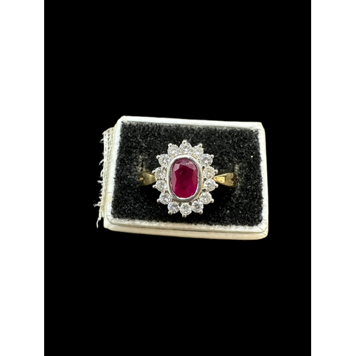 816 - Jewellery: 18ct. gold cluster ring, central ruby within a band of 14 small diamonds. 4.3g.... 