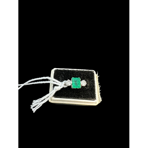 825 - Hallmarked Jewellery: 18ct white gold trilogy ring, central emerald approx. 1ct, flanked by two diam... 