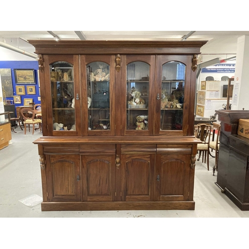 83 - Furniture: 20th cent. Mahogany bookcase with four glazed doors above a base with four drawers and cu... 