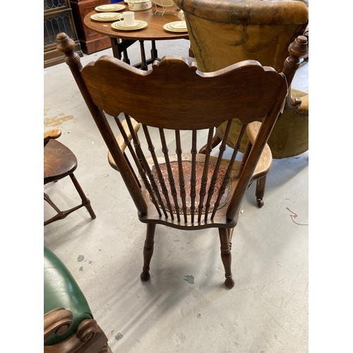 122 - Early 20th cent. Oak spindle back fireside chair with leather upholstered seat.