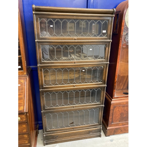 144 - 20th cent. Oak five-section Globe Wernicke with leaded glass fronts. 70ins. x 34ins. x 12ins.