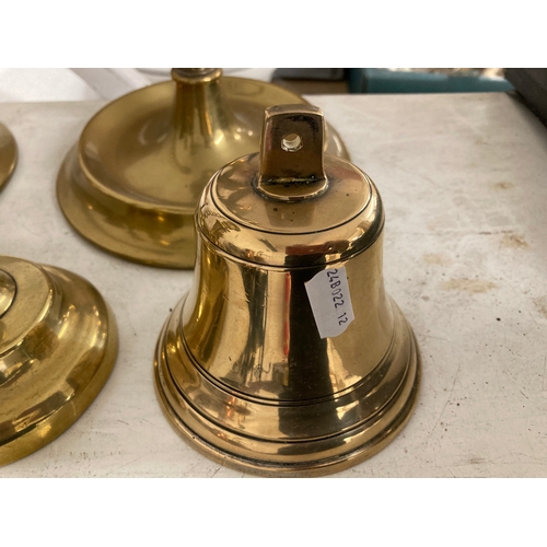 36 - Brass candlesticks open twist on cast base, 20ins. Plus a small pair, 7ins.