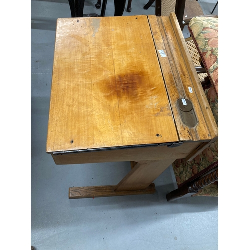 61 - Mid 20th cent. Oak school desk with lift-up lid, pen groove, brass inkwell and sliding cover.