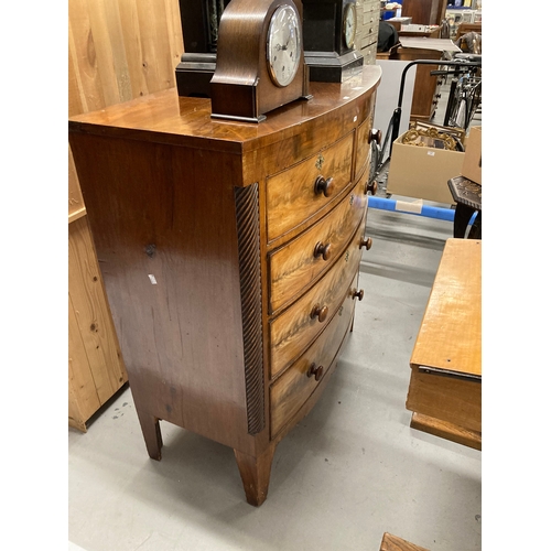 62 - Mahogany bow fronted two over three graduated drawers, canted sides with spiral columns rising off s... 