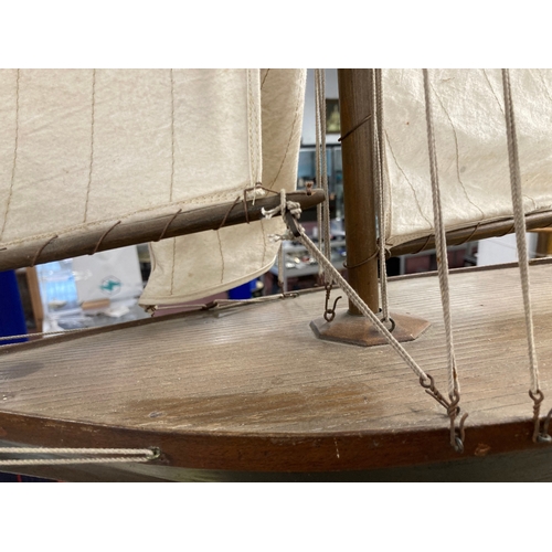 68 - Toys & Games: Treen racing pond yacht fully rigged, red hull, racing keel, on stand. 128cm x 118... 