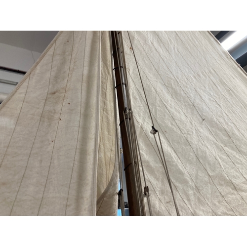 68 - Toys & Games: Treen racing pond yacht fully rigged, red hull, racing keel, on stand. 128cm x 118... 