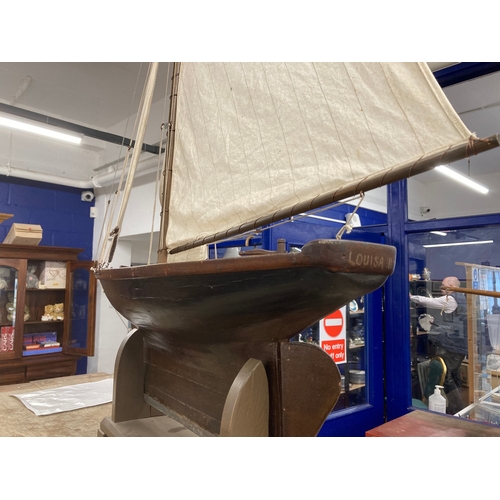 68 - Toys & Games: Treen racing pond yacht fully rigged, red hull, racing keel, on stand. 128cm x 118... 