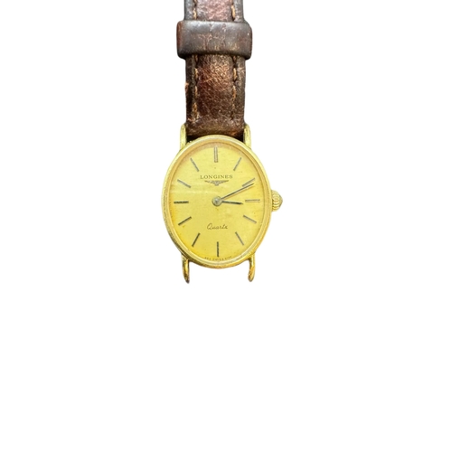 876 - Watches: Ladies 18ct. gold quartz watch with oval dial, 2.1cm. including crown, complete with origin... 