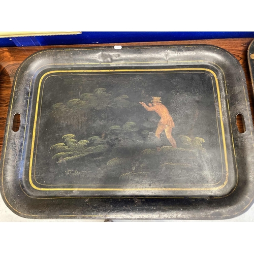 127 - Furniture: THREE REGENCY BLACK JAPANNED TOLE TRAYS: EARLY 19TH CENTURY each pierced with handgrips, ... 